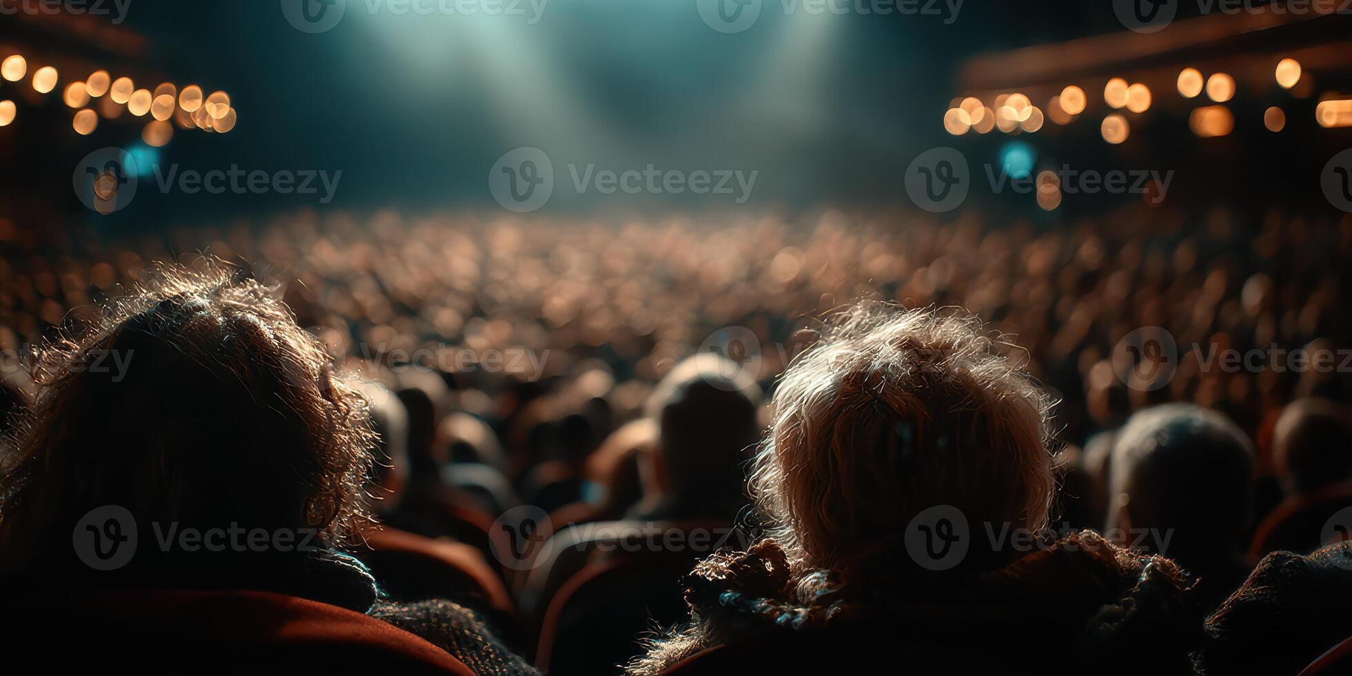 Audience at a theater performance during an evening show with dramatic lighting and anticipation in the air photo