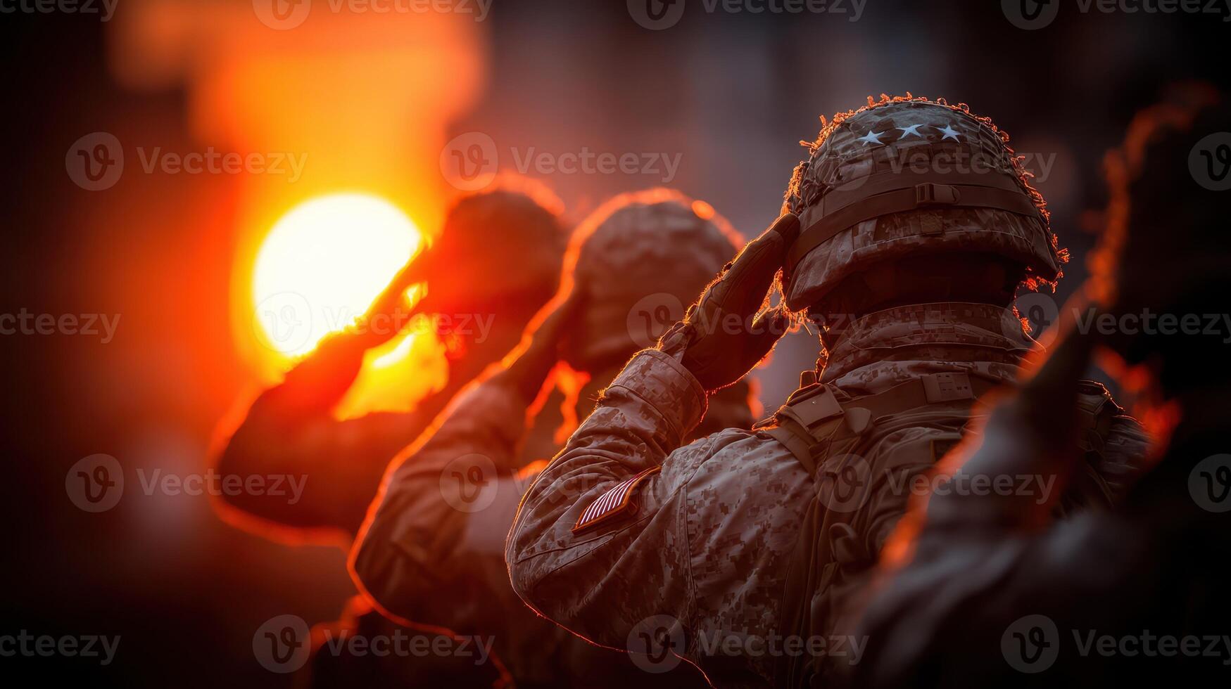 Soldiers saluting as the sun sets during a military ceremony honoring fallen comrades photo