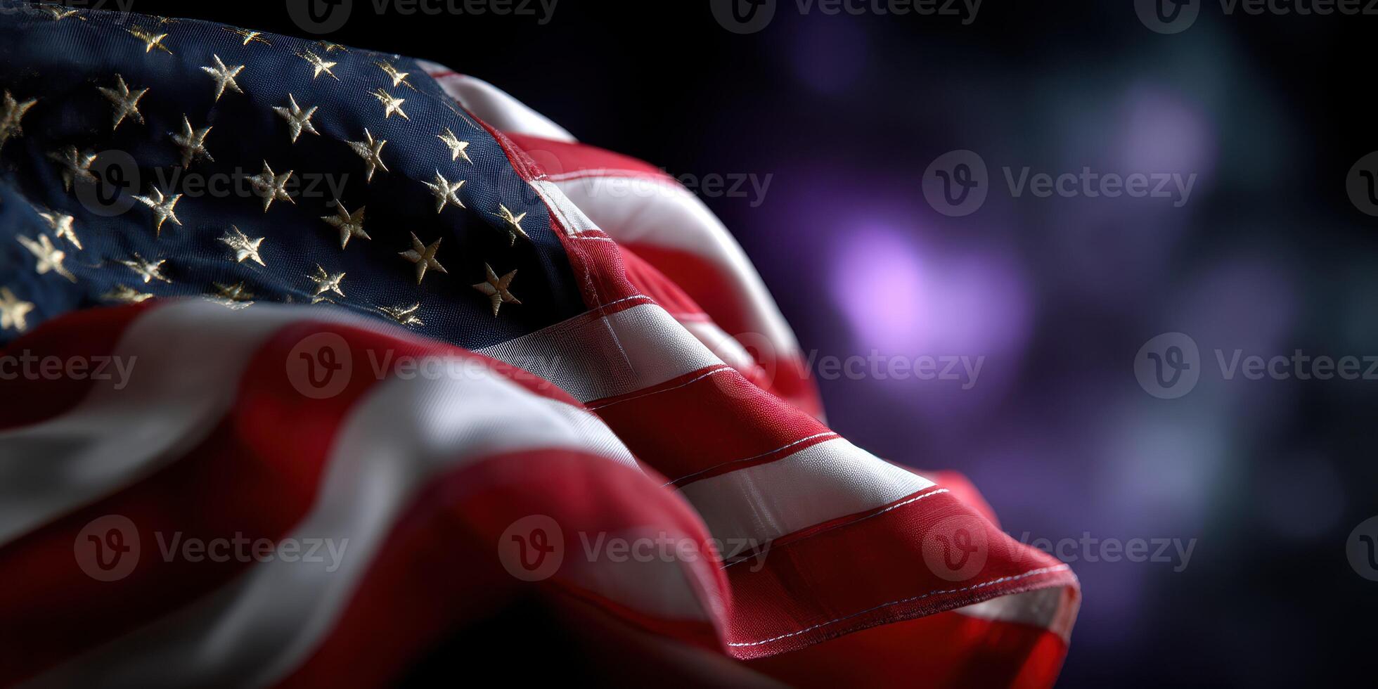 American flag waving gently in the breeze with stars and stripes visible against a dark background photo