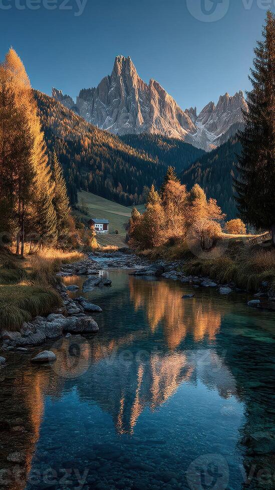 Stunning autumn landscape with mountains and reflection in tranquil river near an alpine village at sunset photo