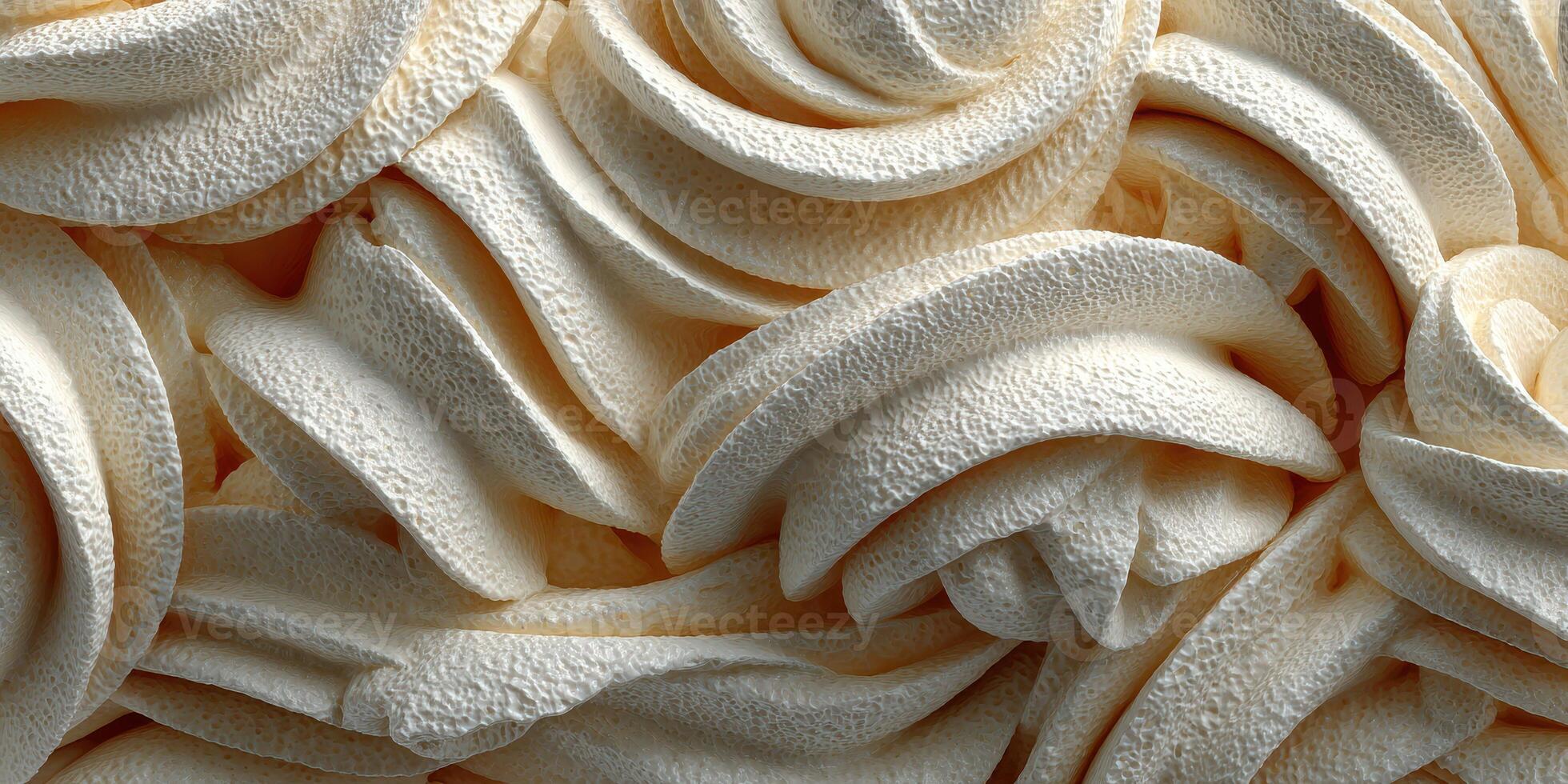 Creamy textured swirls of dessert topping showcased in a close-up view with soft, inviting colors photo
