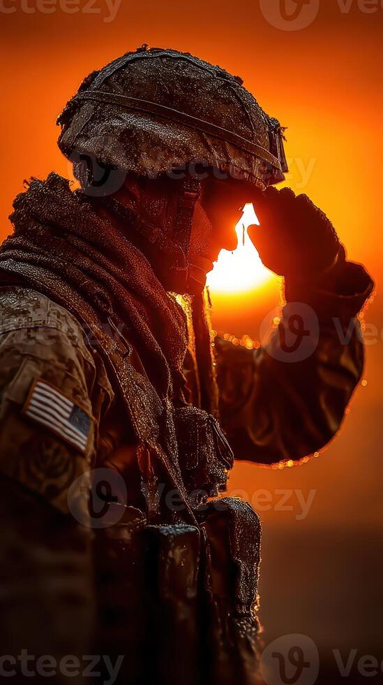 Soldier saluting at sunrise with mist and warm colors in the background during military training exercises photo