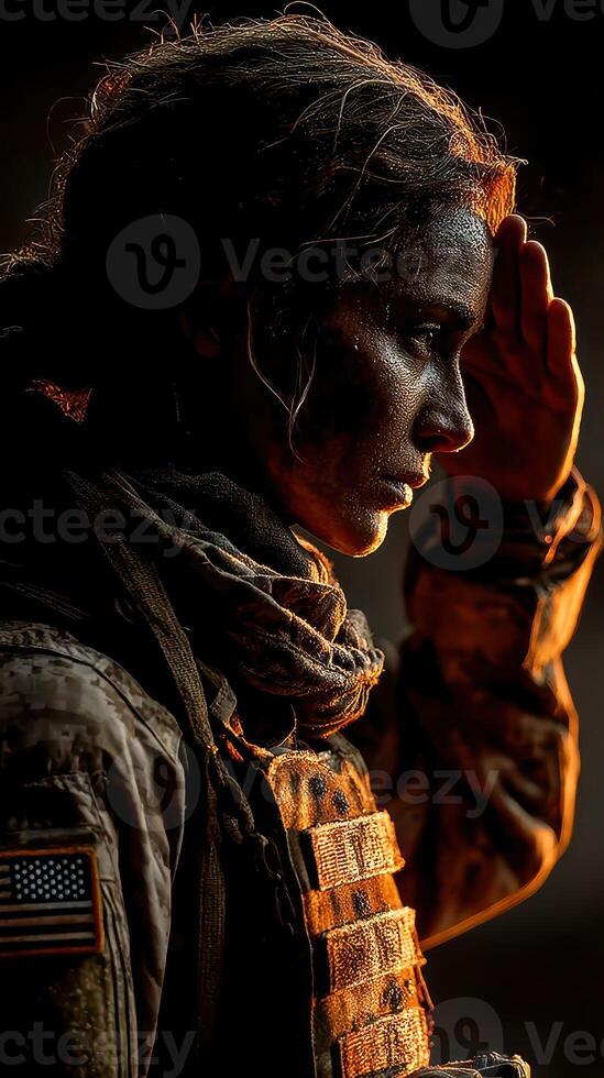 Military woman saluting at sunset in a combat uniform with tactical gear photo