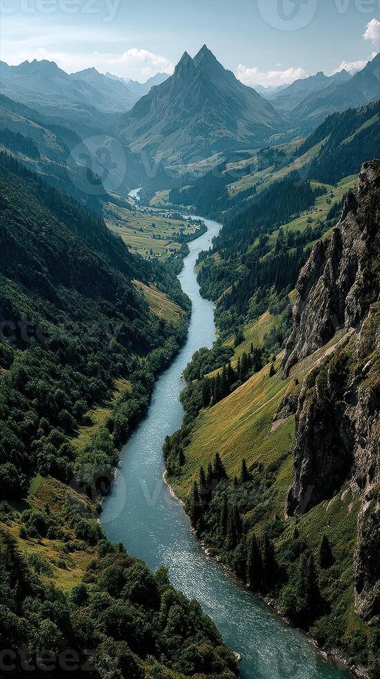 Breathtaking view of a winding river surrounded by lush mountains and greenery in the early afternoon photo