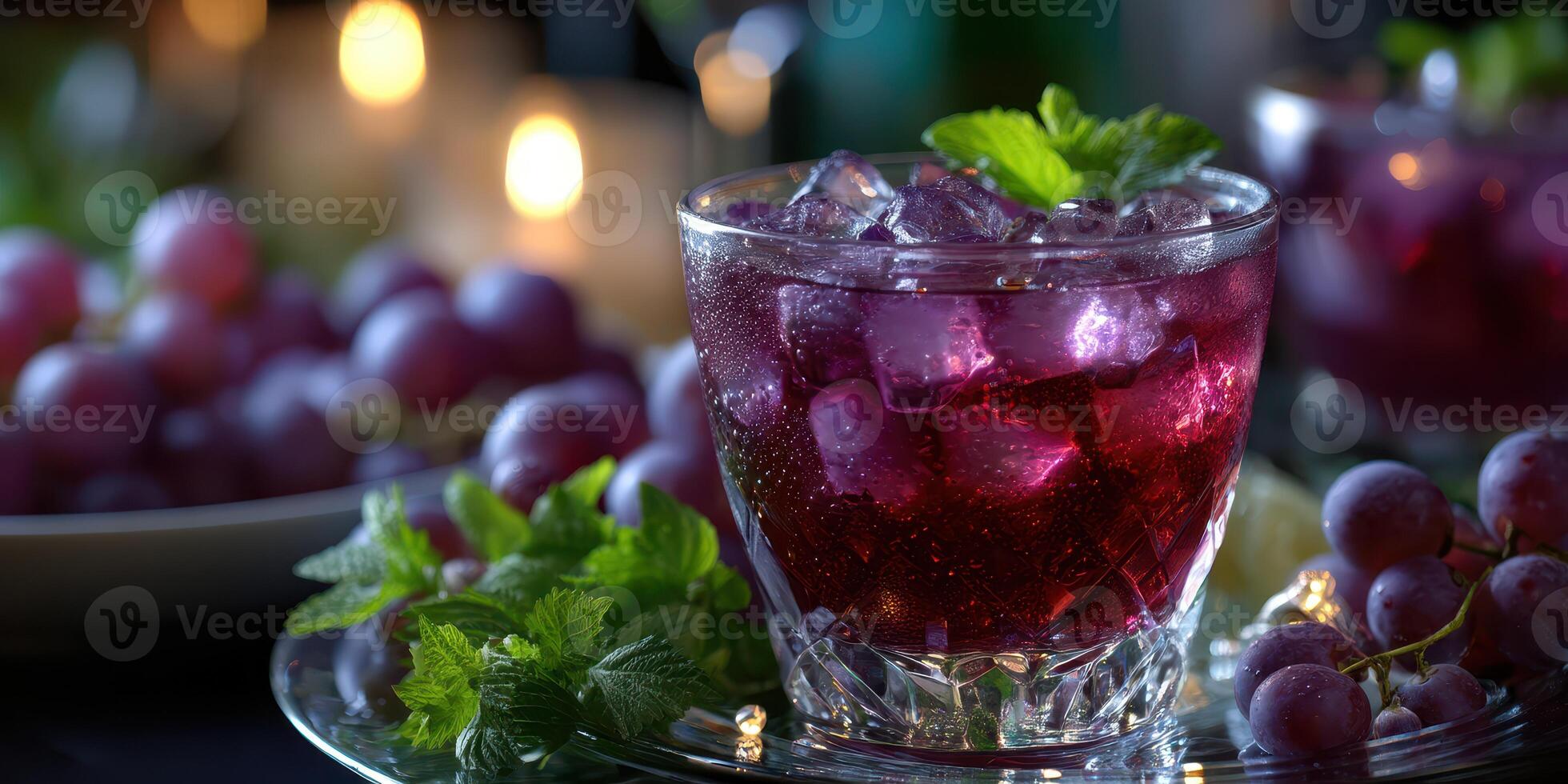 Refreshing grape beverage garnished with mint on a decorative tray surrounded by fresh grapes photo