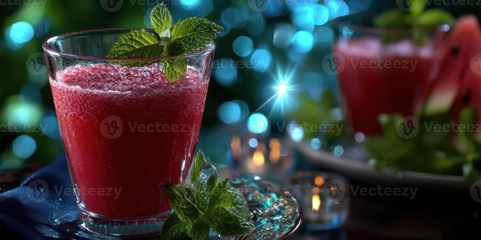 Refreshing watermelon mint beverage served in clear glass with sparkling blue background at a summer gathering photo