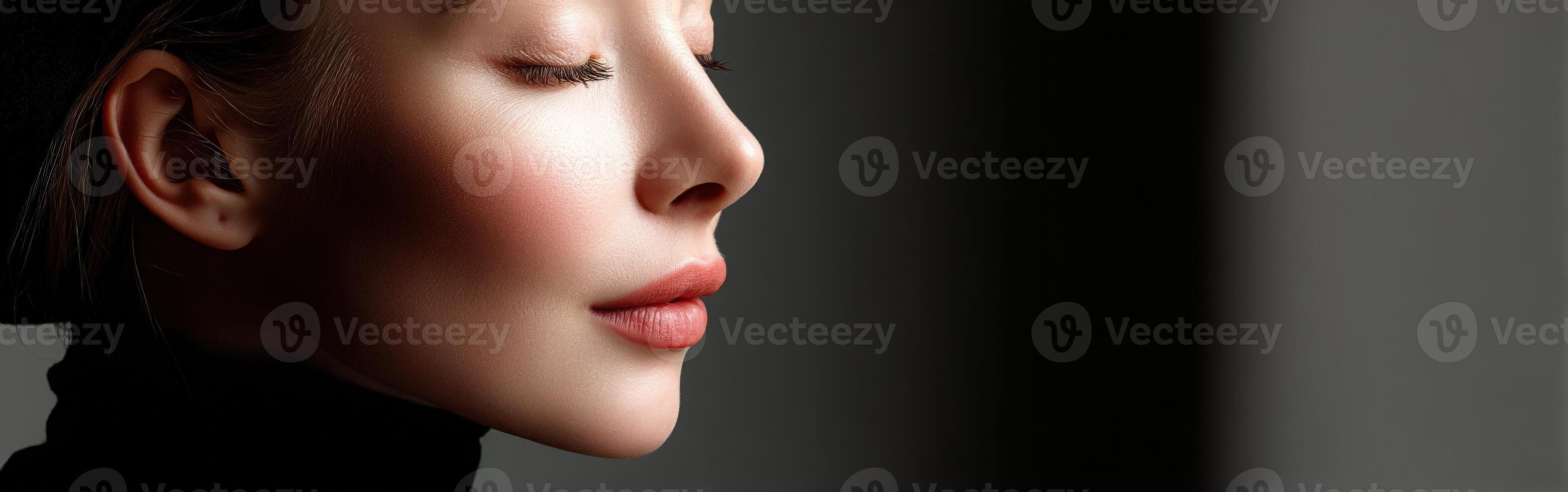 Profile of a woman with closed eyes in soft light setting photo