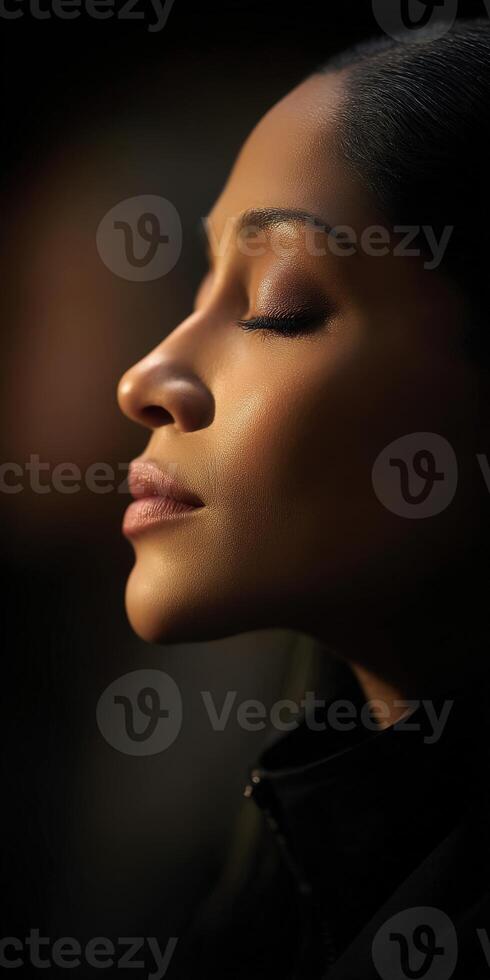 Woman with closed eyes enjoying a moment of peace in natural light photo
