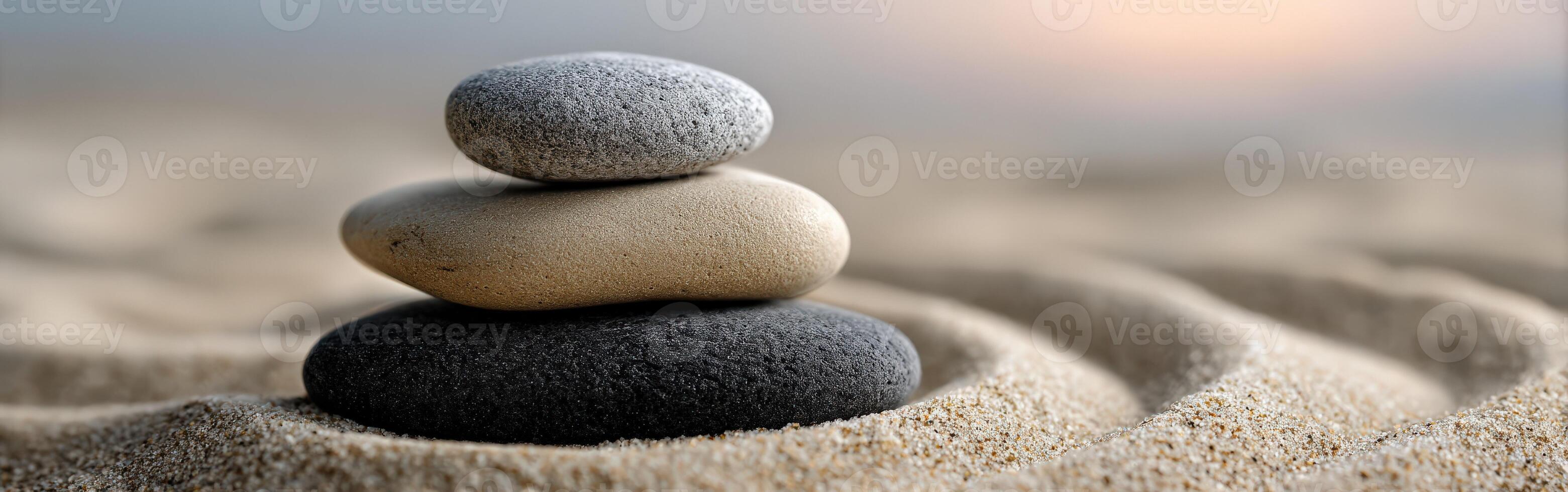Tranquil stacked stones amidst soft sand creating a serene atmosphere photo