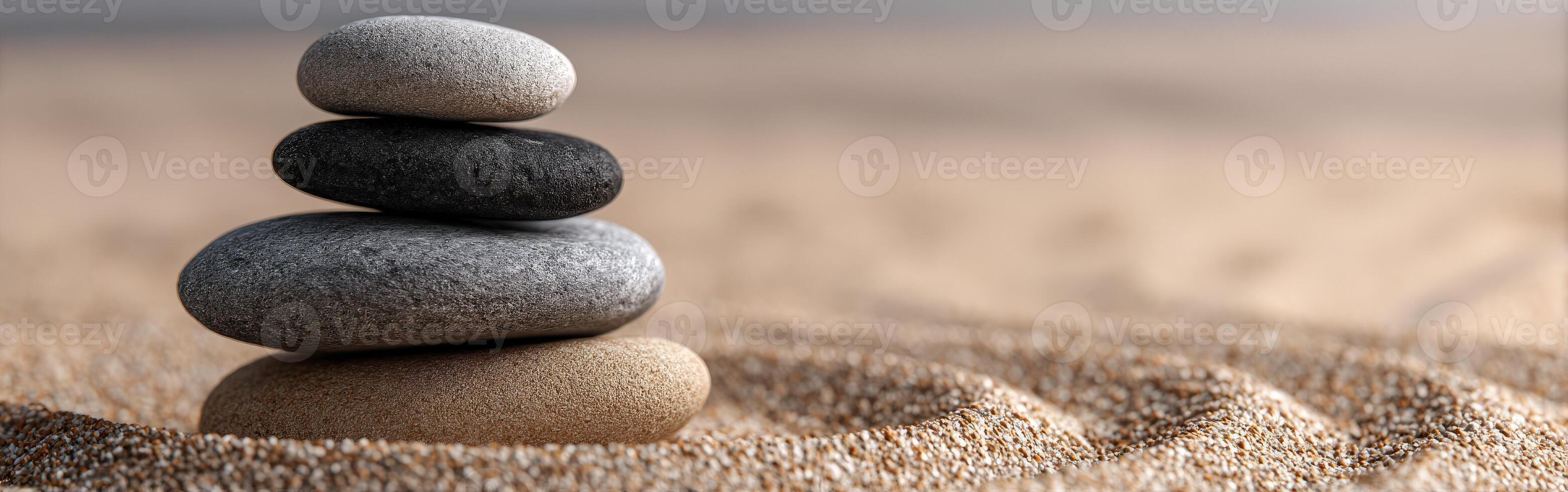 Balanced stones arranged in a calming pattern on sandy surface photo