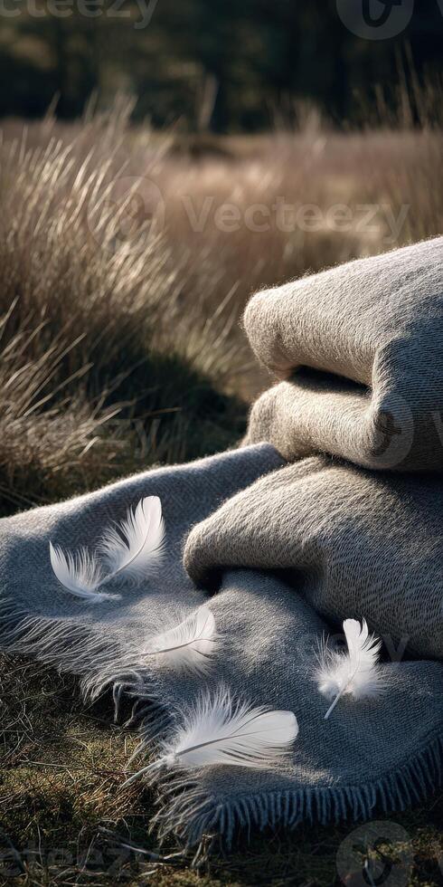 Soft blankets with delicate feathers in a tranquil outdoor setting photo