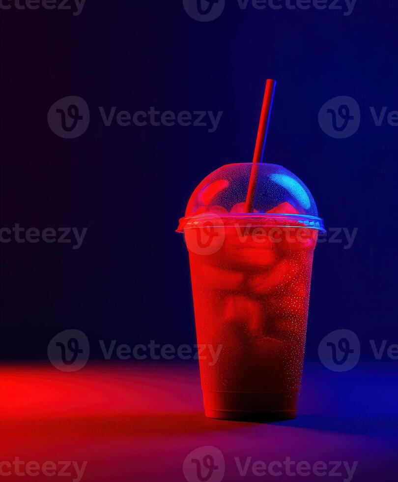 Colorful drink in a cup with ice illuminated by red and blue lights photo