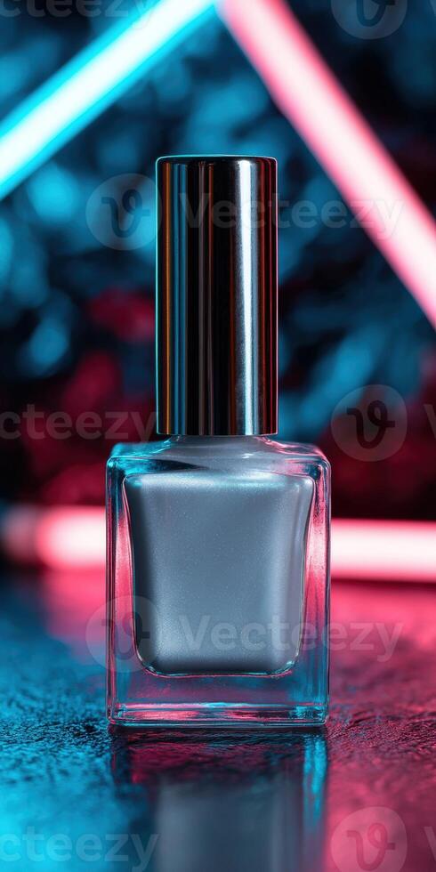 Elegant silver nail polish bottle illuminated by vibrant neon lights photo