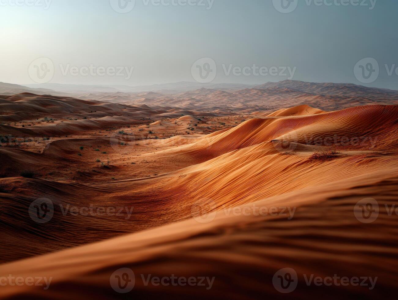 Rolling sand dunes stretch across the arid arabian desert landscape photo