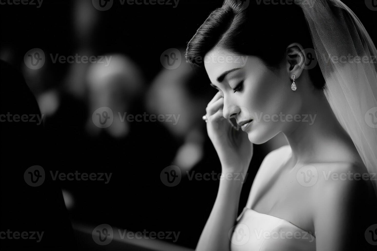 Beautiful bride wipes away tears during wedding ceremony photo