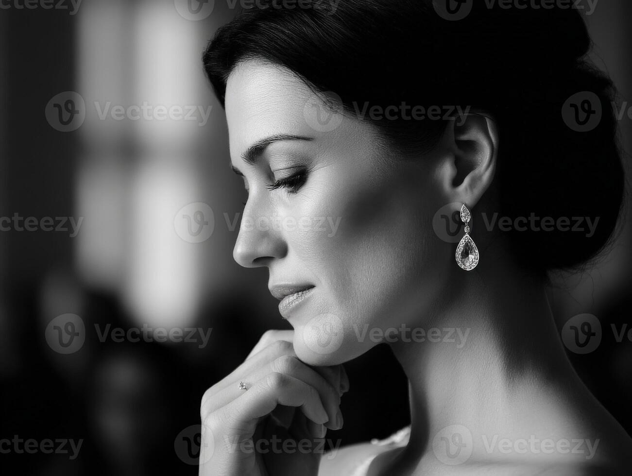 Elegant woman posing in black and white, wearing fine jewelry photo