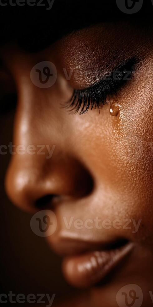 Close Up Portrait of Woman Crying with a Tear on her Cheek photo