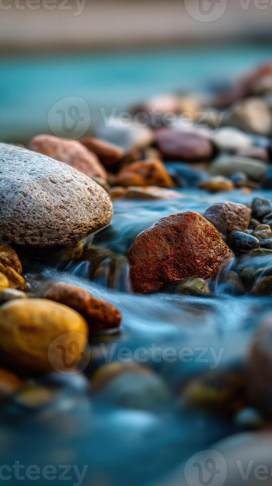 A stream of water flows over rocks in a river photo