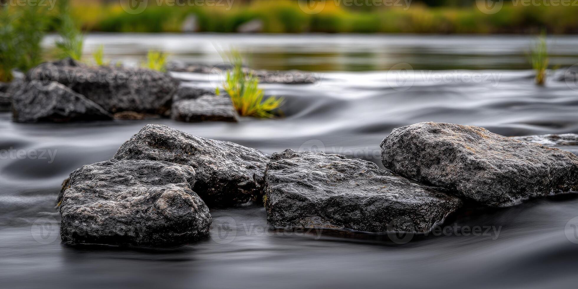 Rocks in a river with blurred water effect photo