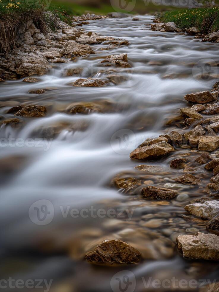 Mountain stream flows between rocks in a peaceful landscape photo