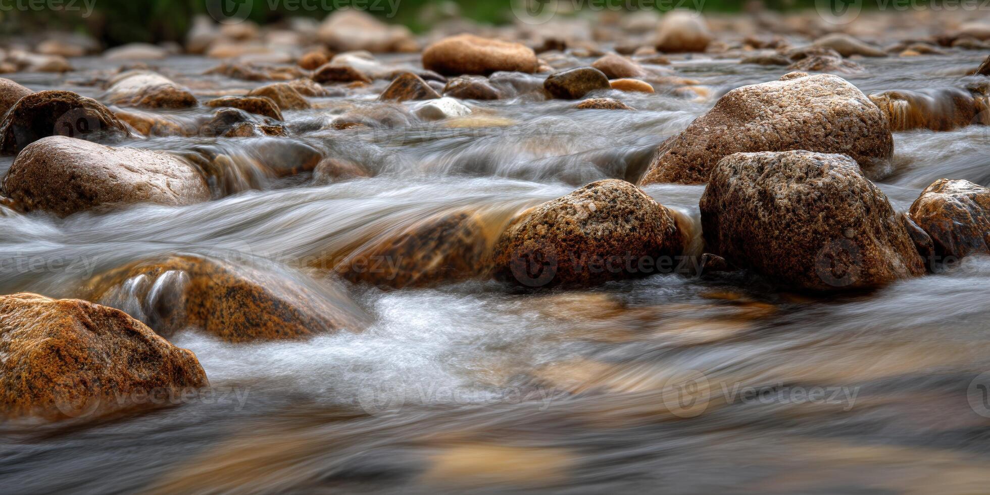 Water flows around rocks in small mountain stream during daytime photo
