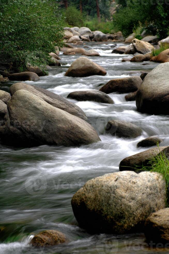 Water flows rapidly through a rocky river in Yosemite National Park photo