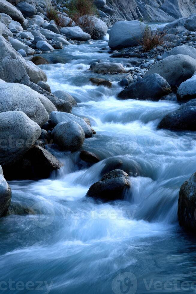 Water flowing over rocks in remote mountain creek photo
