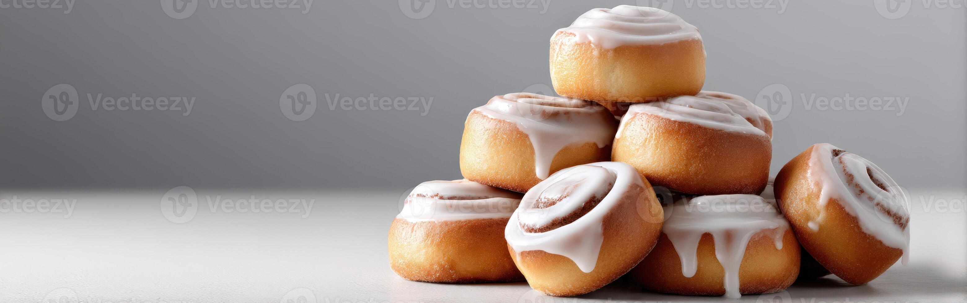 Stack of glazed cinnamon rolls at a bakery studio photo