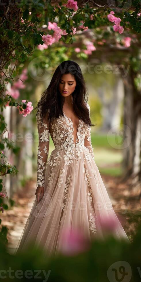 Woman poses in elegant gown in blossoming garden setting photo