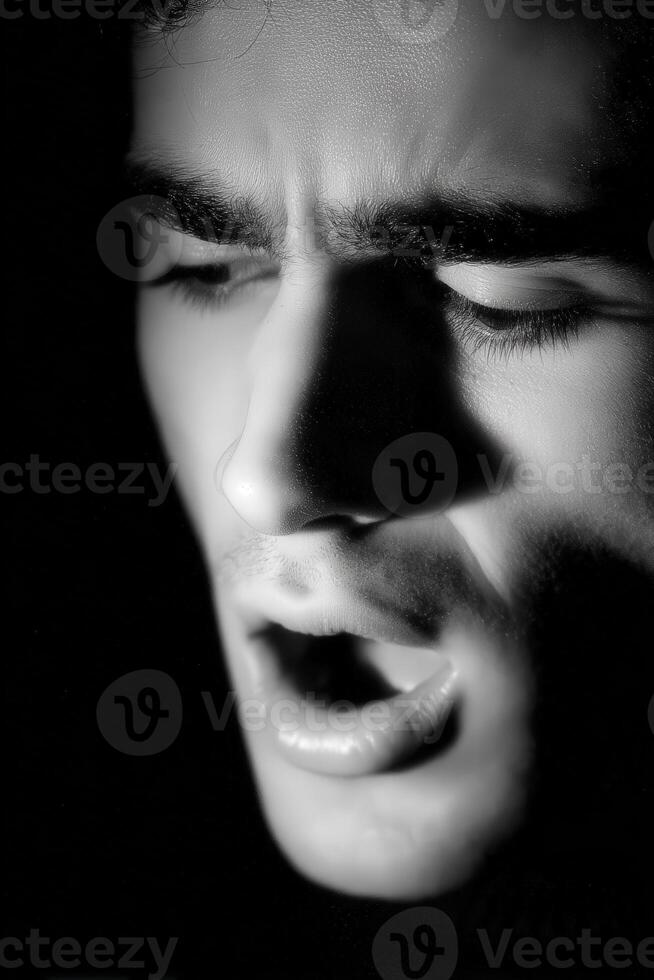 Close up of man singing in a low light setting photo