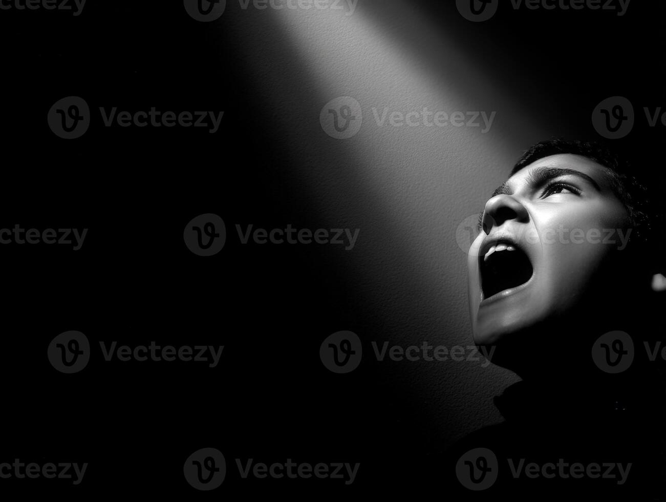 Man shouts towards bright light in the darkness photo