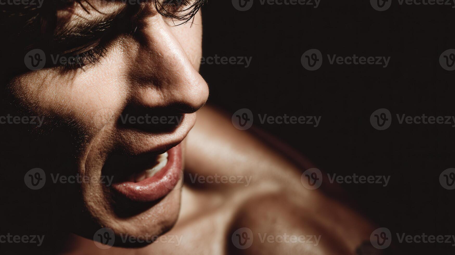 Man with intense expression shouting during dark afternoon photo