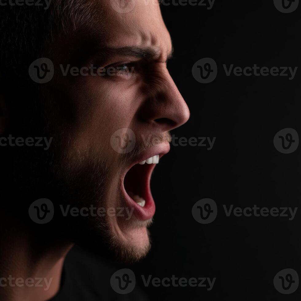 Man shouting in anger in front of black background profile photo