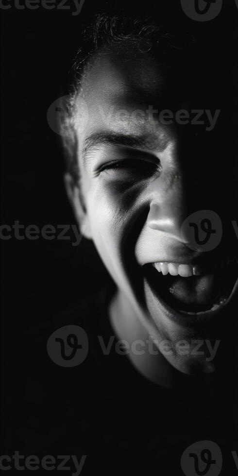 Man's face laughing in grayscale with bright teeth photo