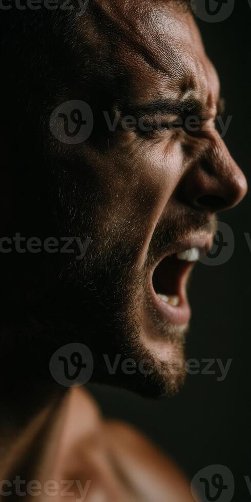 Angered man yelling intensely with his eyes closed tight photo