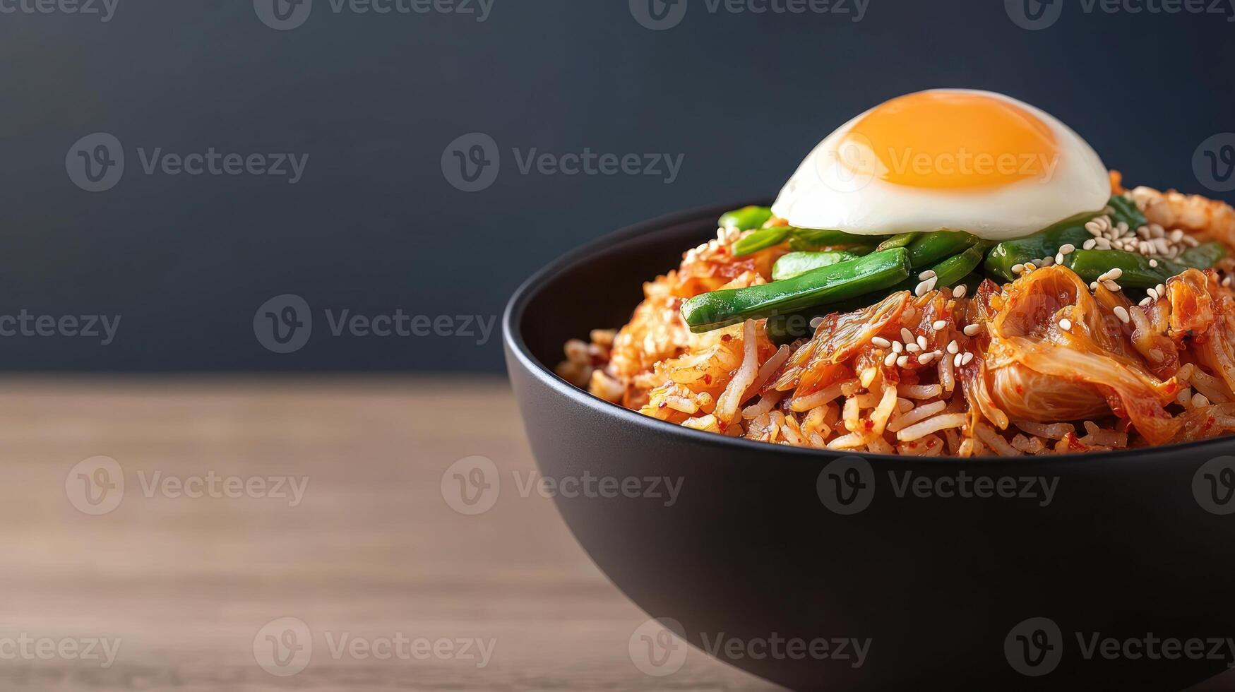 A bowl of Asian fried rice with an egg on top. Food photography for a blog or menu photo