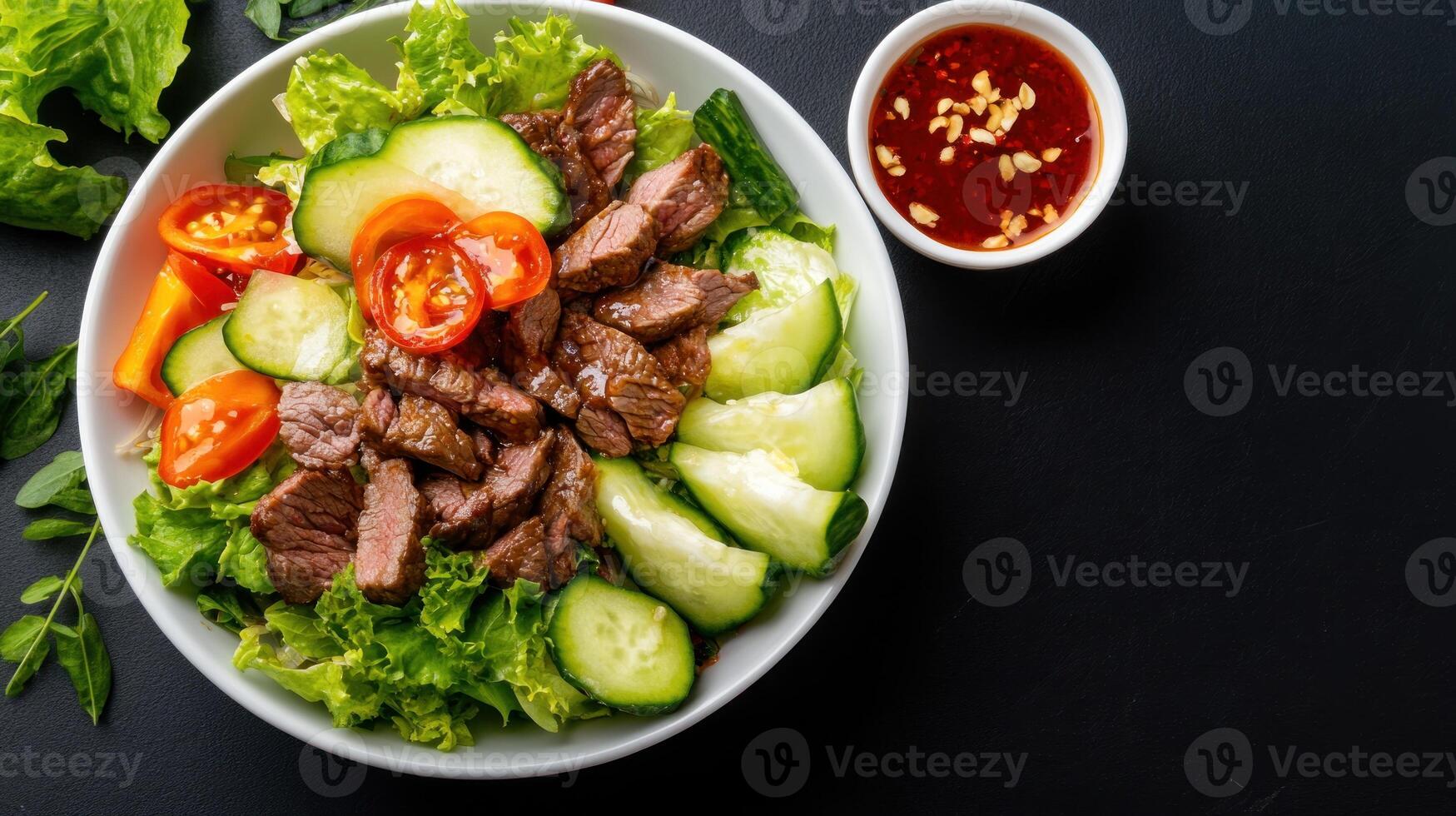 Bowl of grilled beef, salad, tomatoes, cucumber, and sauce. Healthy dining at a restaurant photo
