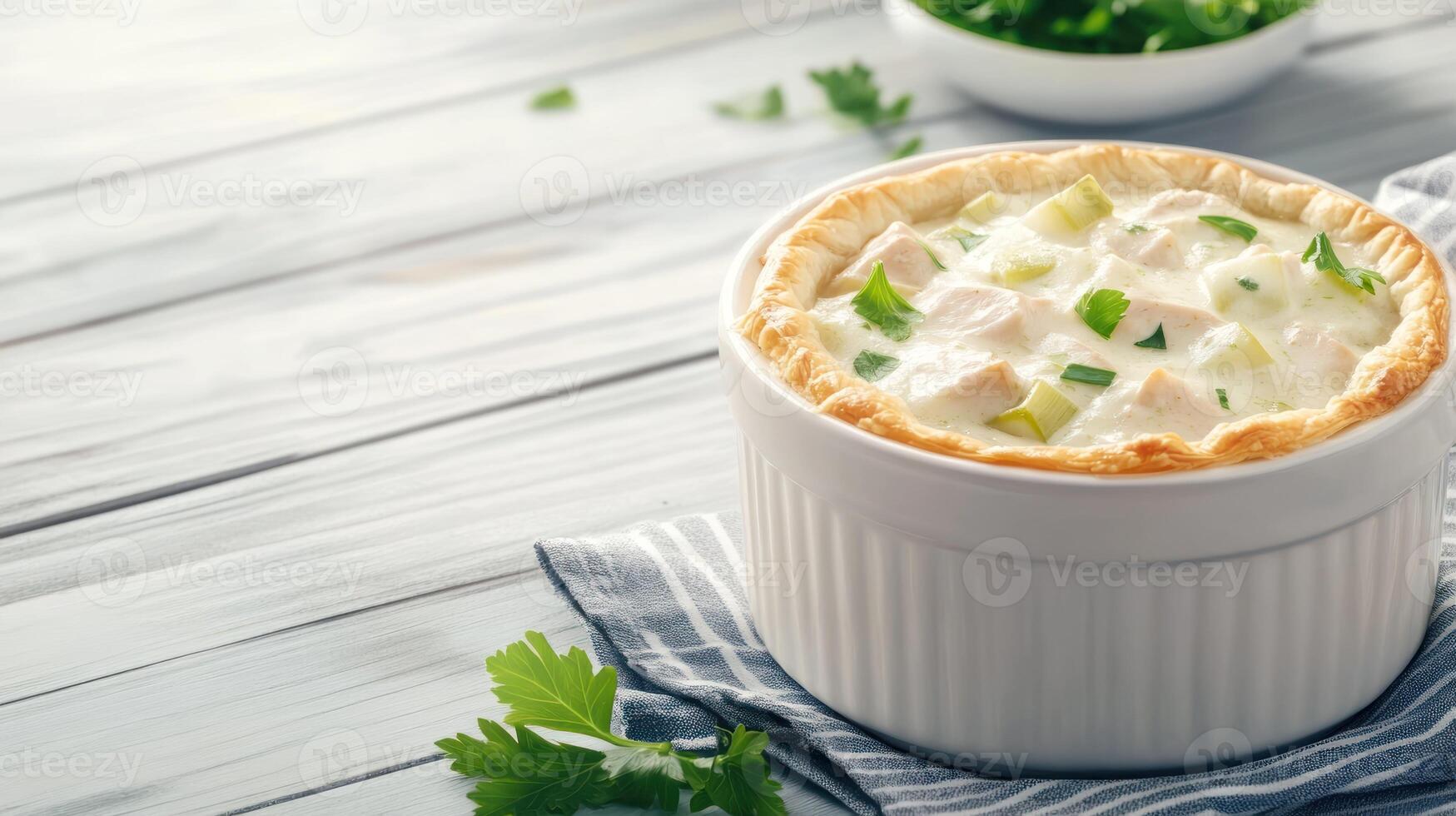 Chicken pot pie in a white baking dish on a rustic wood surface photo