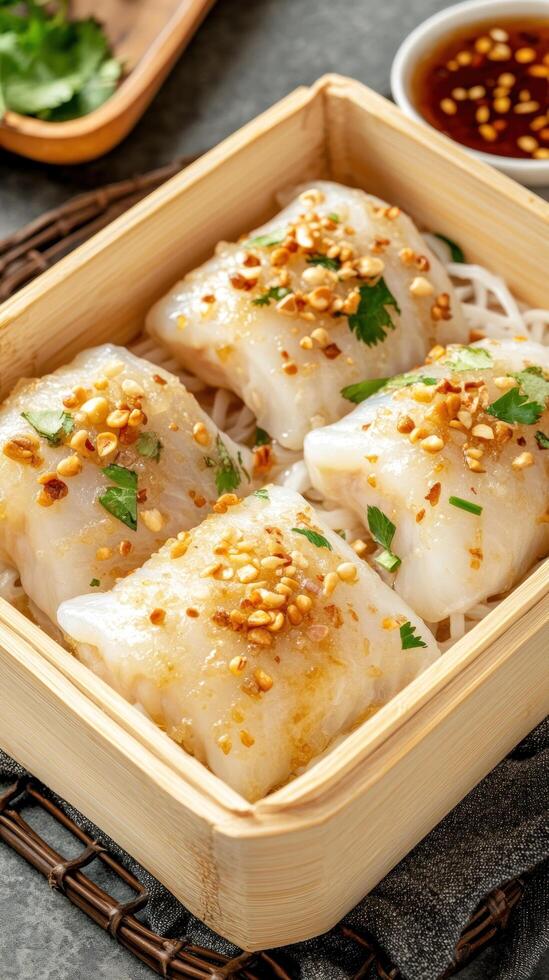 Dumplings served in bamboo steamer, on table with sauce in background. Food photography photo