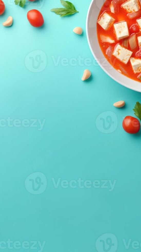 Fresh Tomato Soup. Cubes of tofu sit in a bowl with colorful background, top view for healthy vegan eating photo