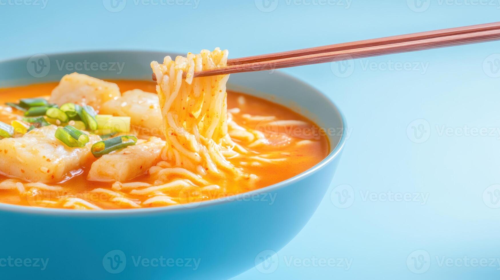 Noodles in bowl being lifted with chopsticks, studio shot for food blog and cooking guides photo