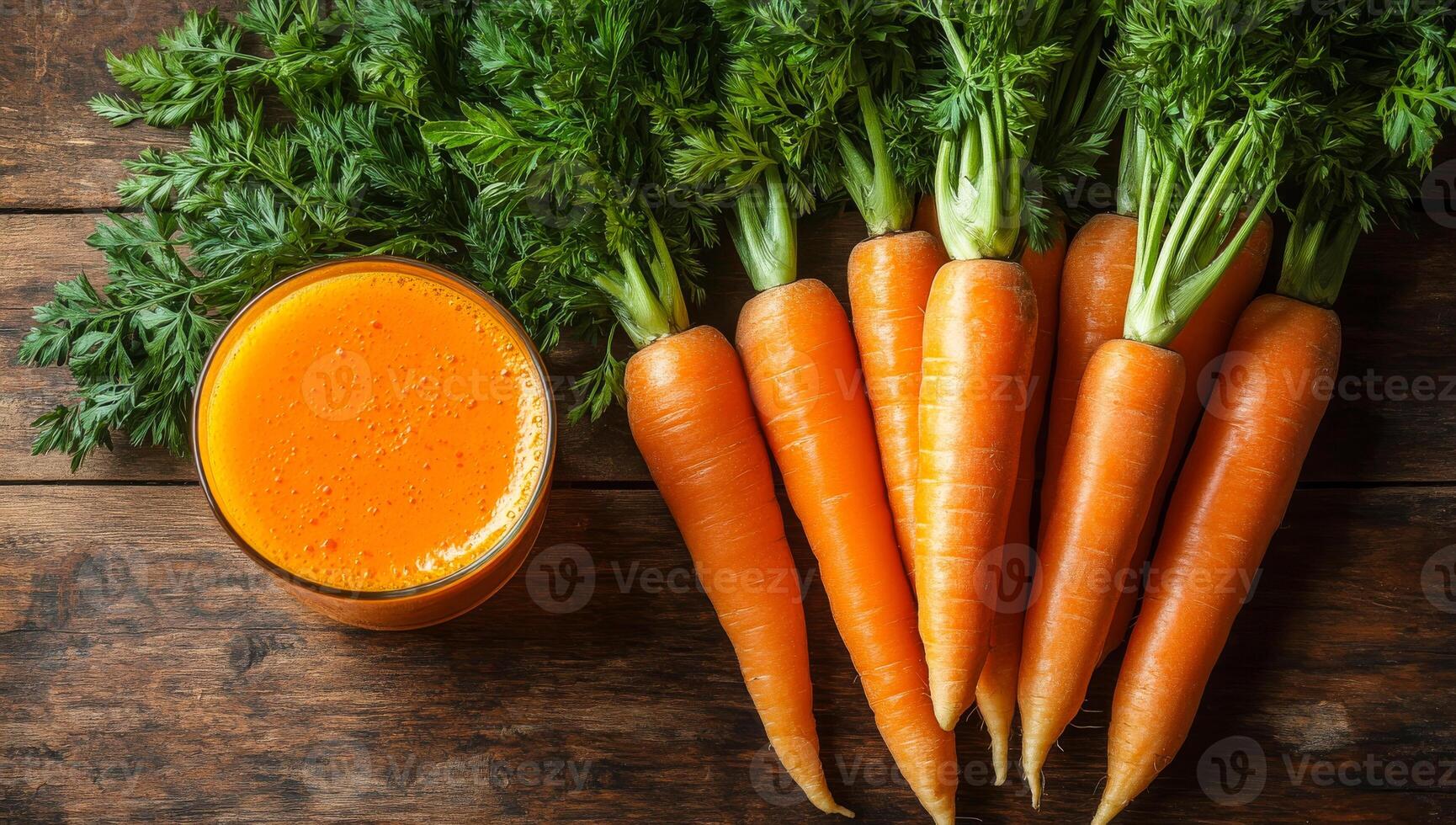 Fresh carrot juice and carrots. Carrots and a glass of bright orange juice on a wooden table highlight their vibrant colors and freshness. photo