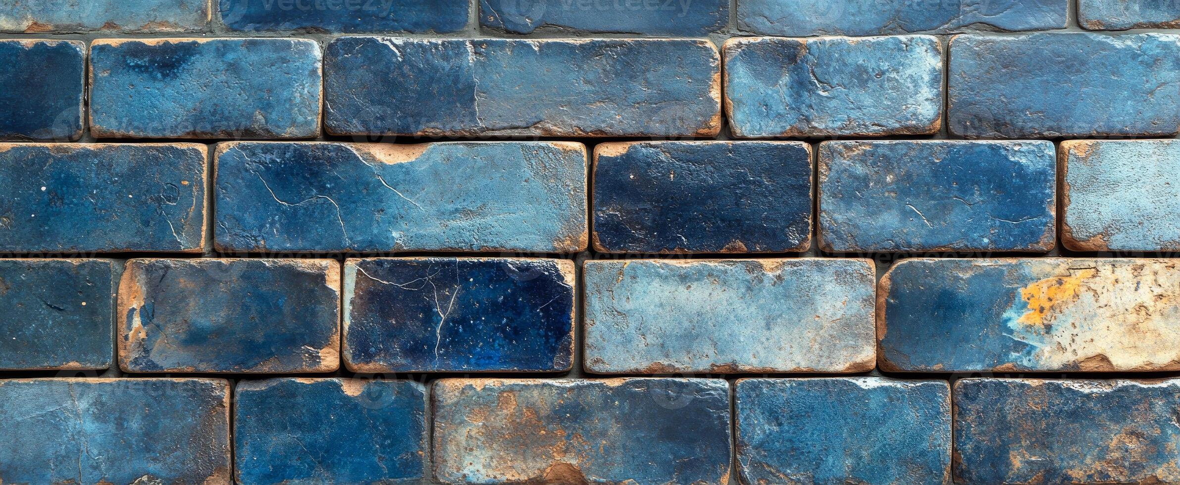 Textured blue brick wall. The wall showcases a variety of blue bricks with different shades and a rustic texture, creating a vibrant backdrop. photo