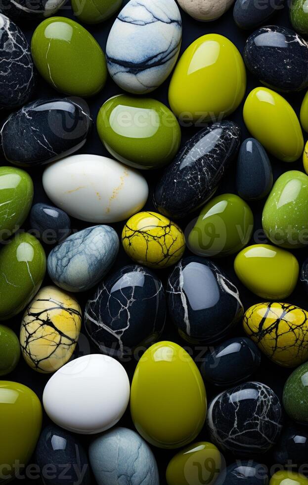 Colorful stones of all shapes. A collection of smooth, vibrant stones in green, black, and white, showcasing their natural beauty. photo