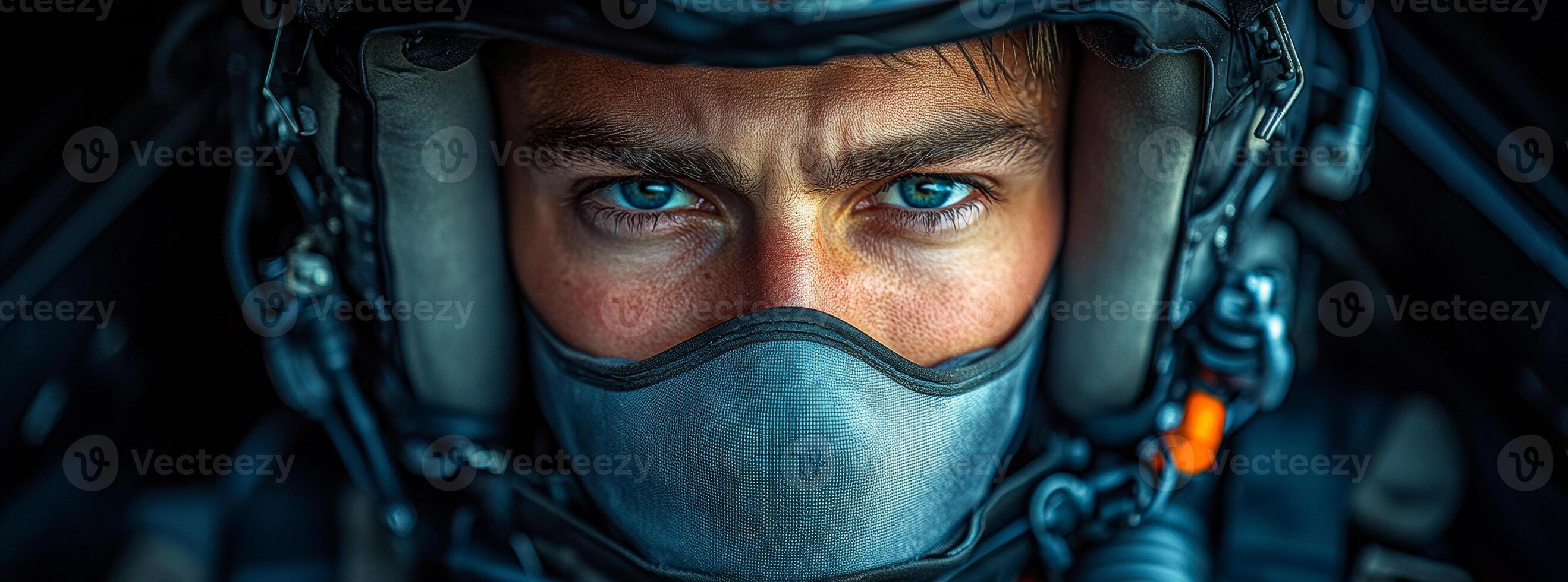 Pilot set for takeoff. A determined pilot prepares for flight, showcasing intense blue eyes and wearing a protective helmet and mask. photo