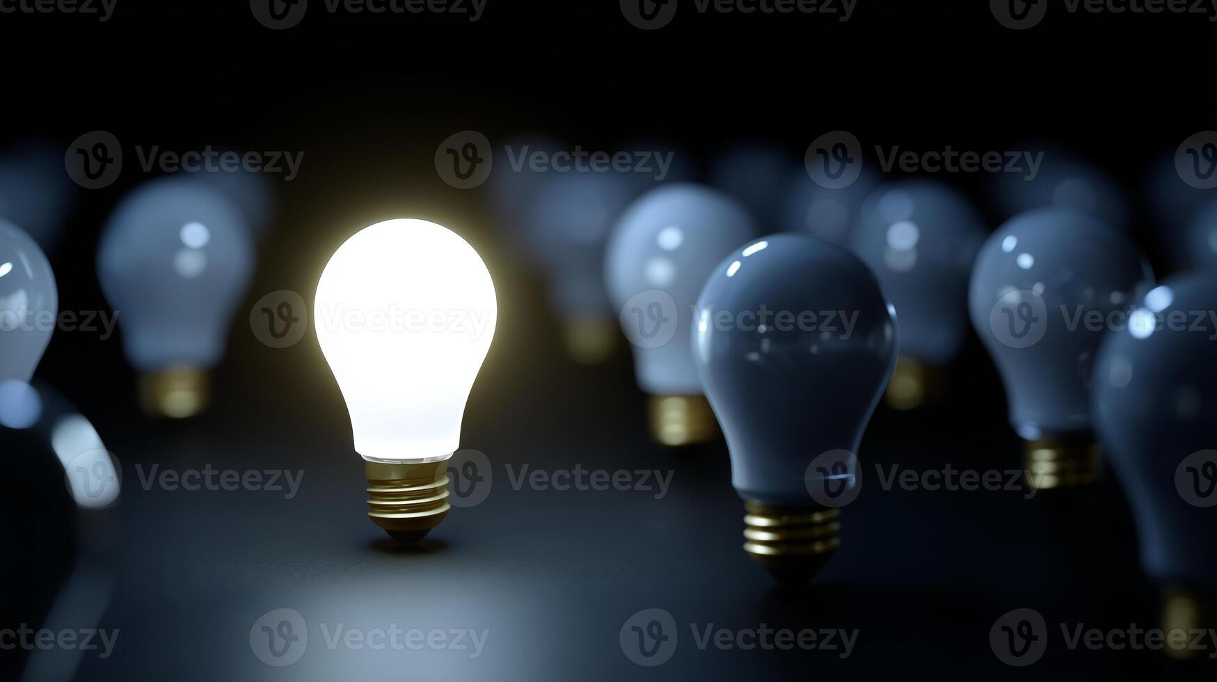 Unique light bulb shines brightest among many others in a dark setting to symbolize innovation and ideas photo