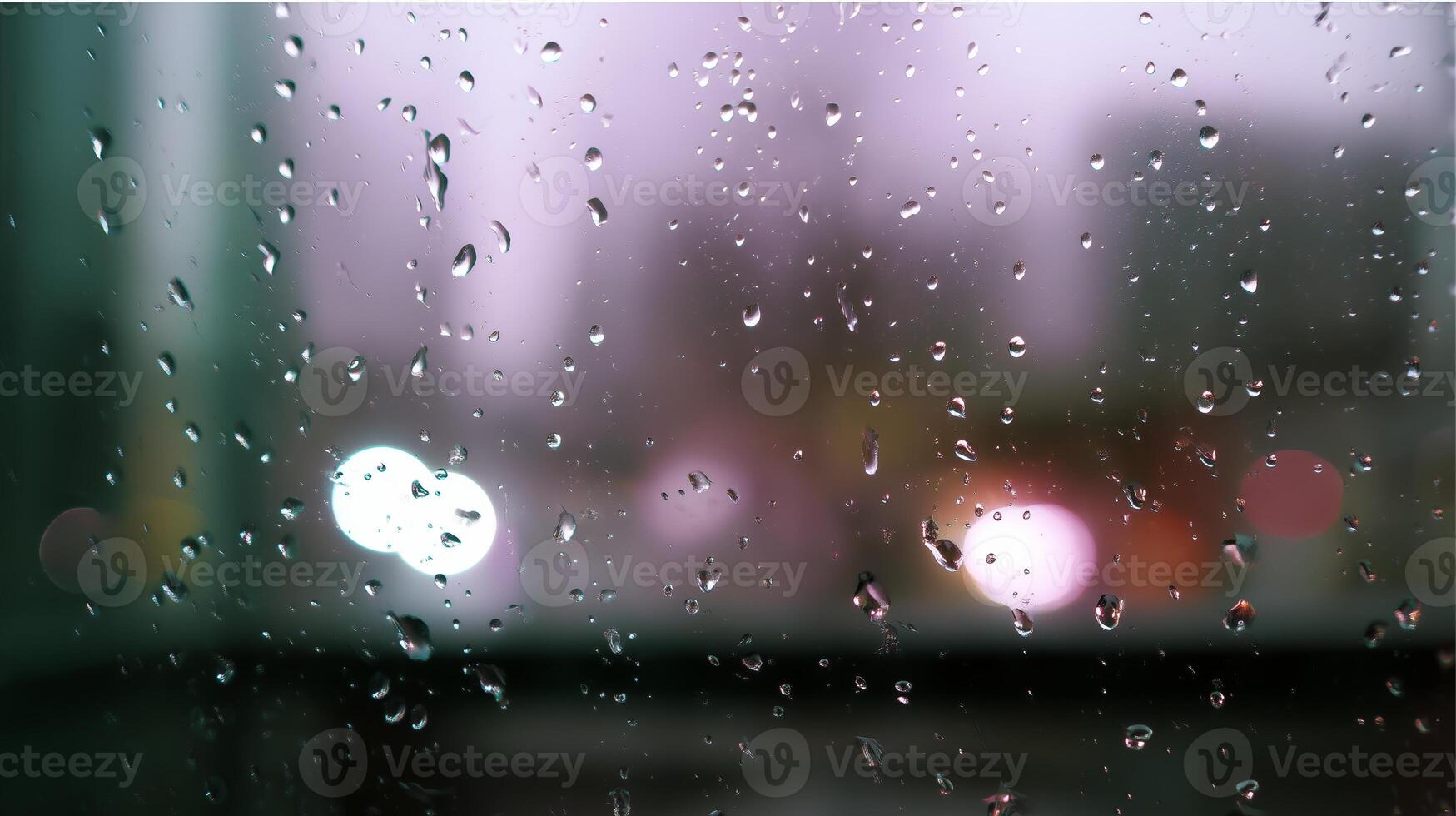 Raindrops on glass create a blurred urban view during a rainy evening photo
