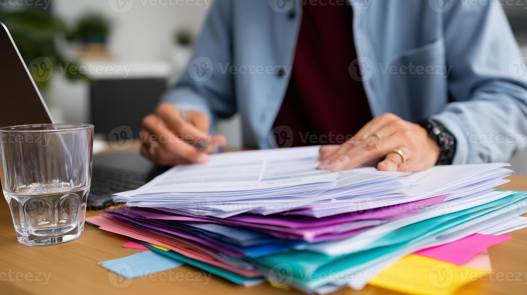 Organizing paperwork and managing tasks at a work desk in a home office setting during daylight hours photo
