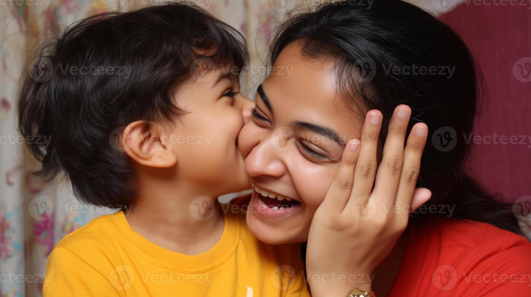 Mother and son share a joyful moment indoors full of laughter and affection during a cozy evening photo
