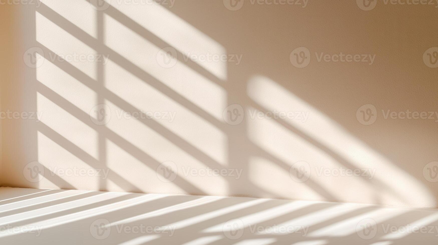 Natural light creating an abstract pattern of shadows from a window on a beige wall and floor, perfect for backgrounds and design projects photo